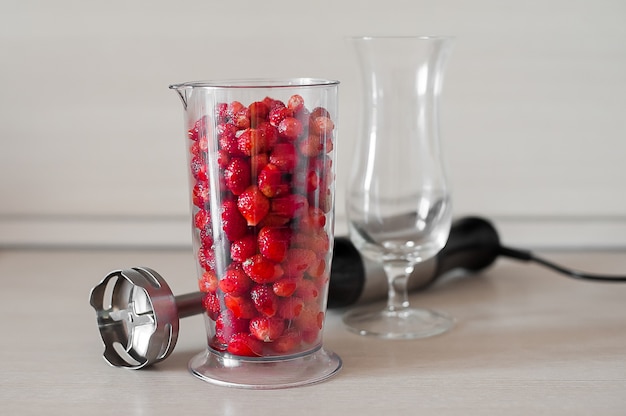 Close up of blender shaker with fruits and berries smoothie