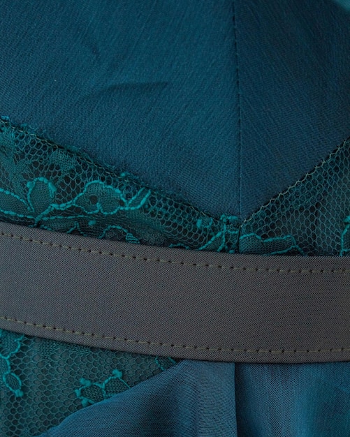 Photo a close up of a blue lace dress with a brown band.