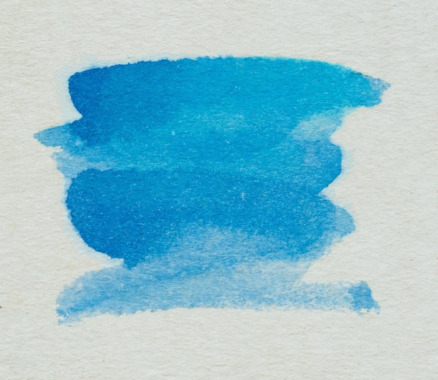 Close-up of blue paint over white background