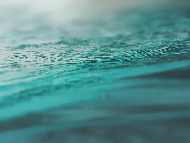 a close up of a blue water with a green background