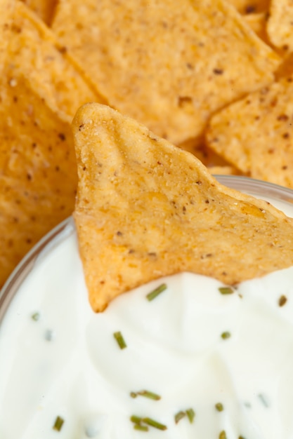 Close up of a bowl of white dip with herbs