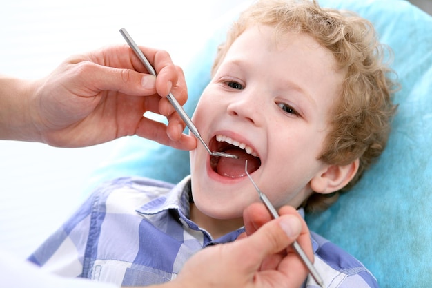 Close up of boy having his teeth examined by a dentist