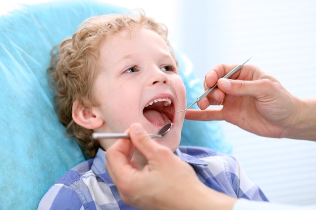 Close up of boy having his teeth examined by a dentist.