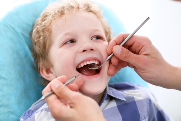 Close up of boy having his teeth examined by a dentist.