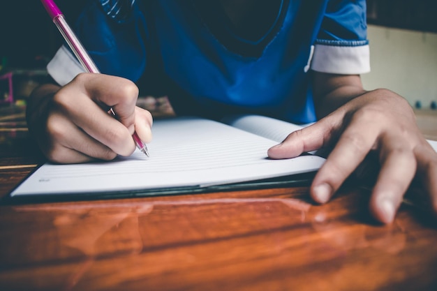 Close-up of boy studying at home