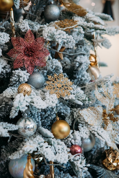 Close-up of branches of a New Year tree decorated with snowflakes