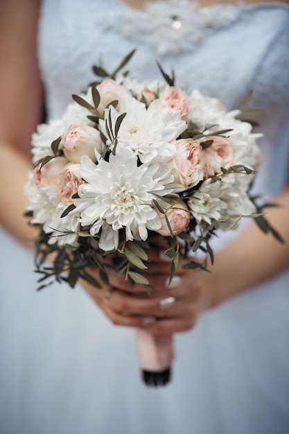 close-up of the bride’s bouquet, girl holds big flowers in her hands