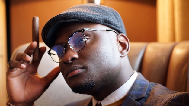 Close-up of a brooding African-American gaze from behind his glasses. Close-up portrait of a black man