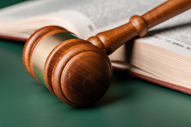 Close up of a brown wooden gavel and book