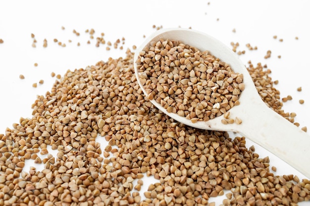 Close up of buckwheat grains isolated on white background Top view