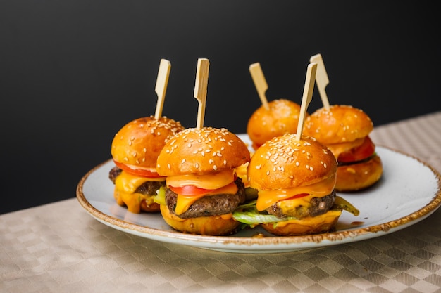 Close-up of burger in plate on table against black background