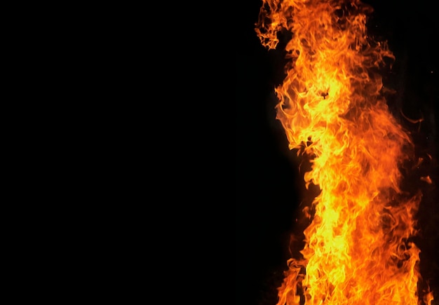 Close up burning flames on black background for graphic design or wallpaper