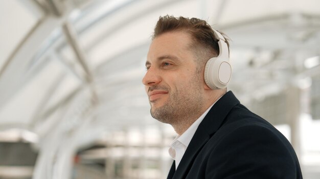 Photo close up of business man moving his head to music while listening song urbane