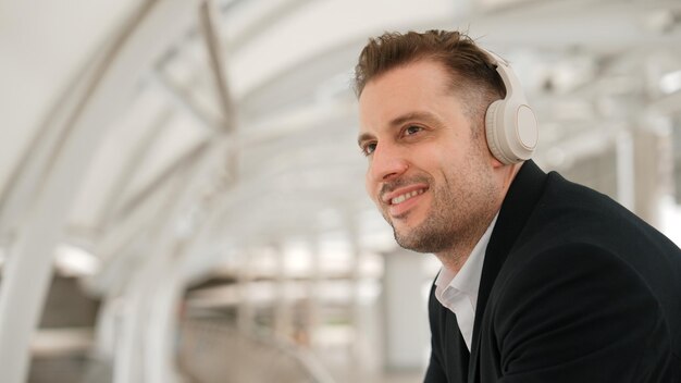 Close up of business man moving his head to music while listening song urbane