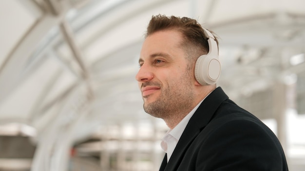 Close up of business man moving his head to music while listening song urbane