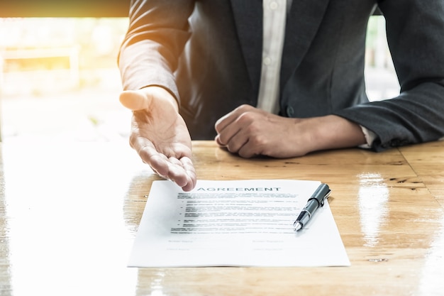 Close up business man waiting signing agreement.