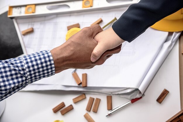 Photo close-up of business people shaking hands on table