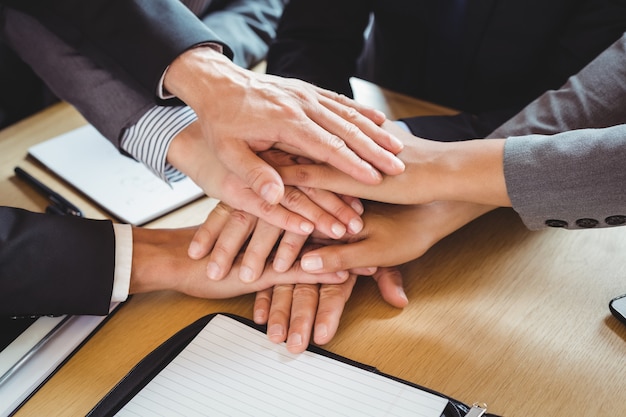 Close-up of business people stacking hands