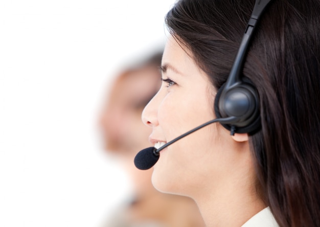 Close-up of business people with headset on standing against a white background