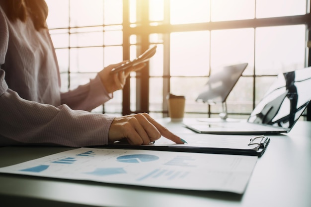 Close up of Business team analyzing income charts and graphs with modern laptop computer Business analysis and strategy concept