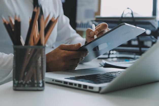 Close up of Business team analyzing income charts and graphs with modern laptop computer Business analysis and strategy concept