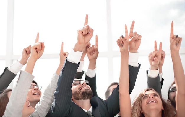 Close up business team pointing up to the copy space