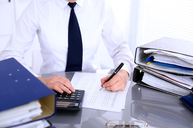 Close up of business woman making report calculating or checking balance