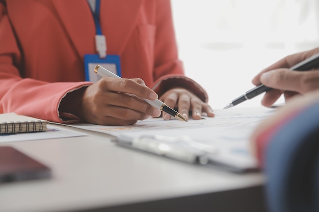 Close up Business woman using calculator and laptop for do math finance on wooden desk tax accounting statistics and analytical research concept