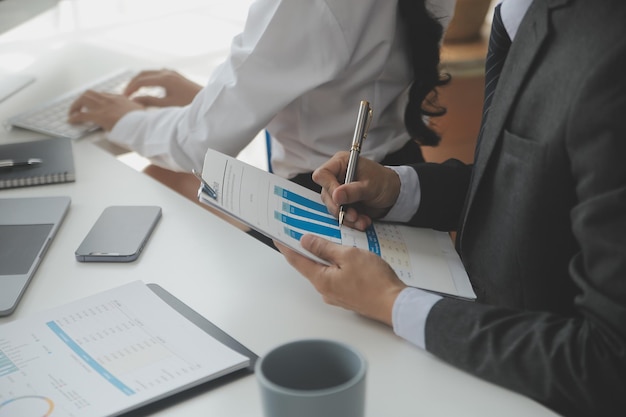 Close up Business woman using calculator and laptop for do math finance on wooden desk tax accounting statistics and analytical research concept