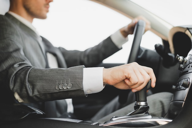 Close-up of businessman driving the car