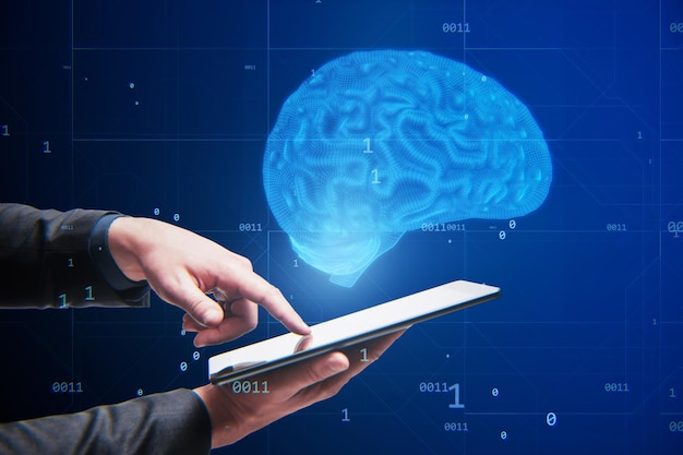 Close up of businessman hand pointing at tablet with creative blue brain hologram on blurry background Neurology anatomy ai and machine learning concept