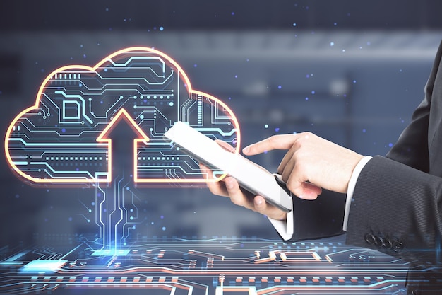 Close up of businessman hands pointing at mobile phone with glowing circuit cloud hologram on blurry office interior background Cloud computing and database concept