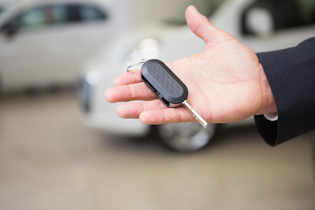 Close up of businessman holding car key