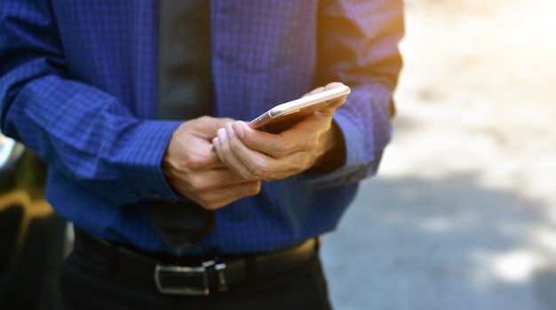 Close up businessman holding mobile smart phone technology