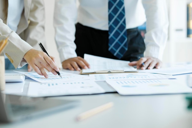 Close up of businessman is analyzing stock marketing on laptop looking at financial and statistic