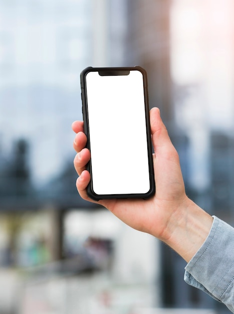 Close-up of businessman's hand holding mobile phone with white screen display