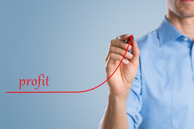 Close up of businessman using marker to draw a growing graph