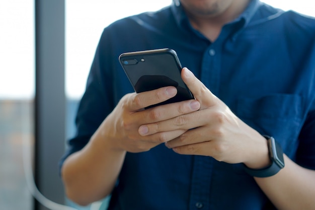 Close up businessman using smartphone for working