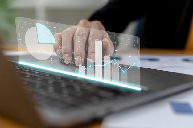 Close-up businesswoman hand using a laptop touchpad to open a financial report, a graphic showing financial and numerical growth data. The concept of financial management to grow and be profitable.