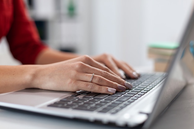 Close up of businesswoman manager hands fingers typing