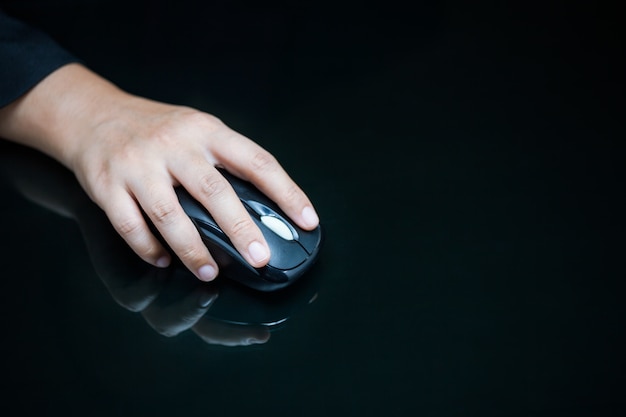 Close-up of businesswoman's hand on computer mouse