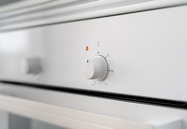 Close up of the buttonsregulators on a white stove kitchen