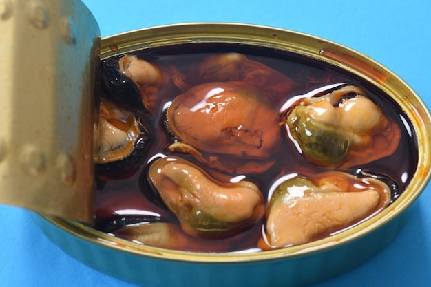 Close up of a can of mussel on blue background