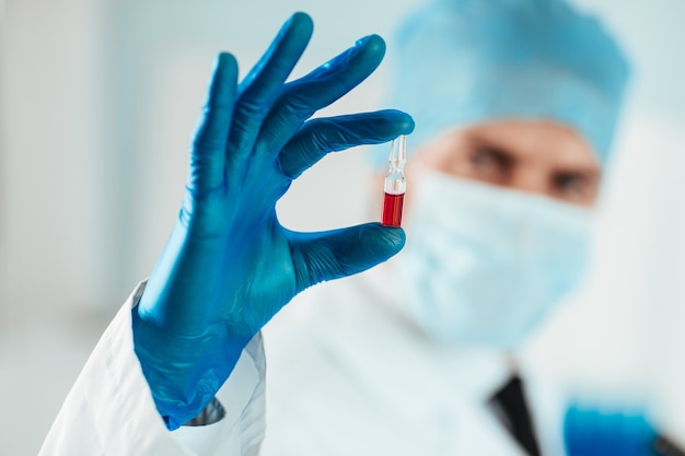 Close up. capsule with a vaccine in the hands of a scientist. photo with a copy-space.