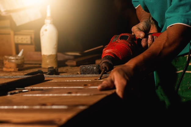 Close-up of a carpenter using a circular saw or a tool to cut wooden planks To make furniture in homes and residences, hotels, rooms made of wood.