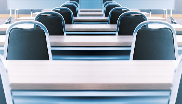 Close up the chair in in seminar room with a speaker table in the middle of the stage