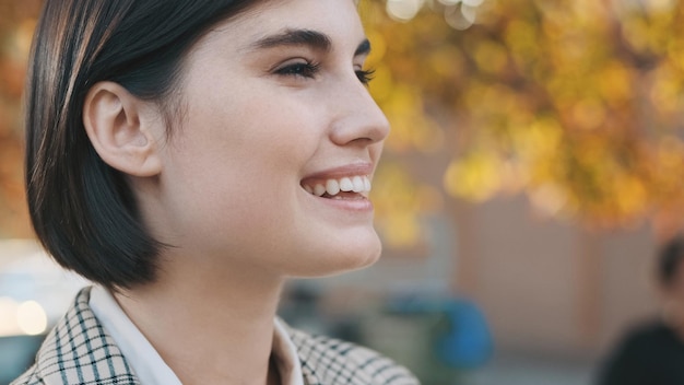 Close up cheerful lady smiling outdoor Portrait of young attractive businesswoman on city street Face expression