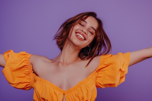 Photo close up of cheerful woman in stylish orange clothes on purple background