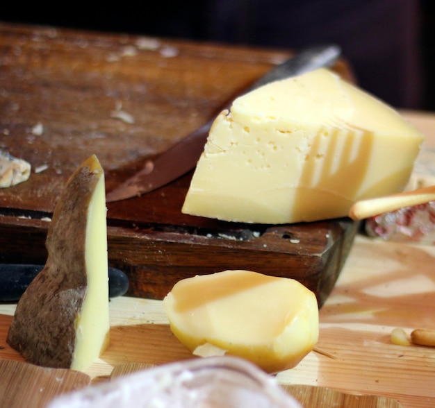 Close-up of cheese and cutting board on table