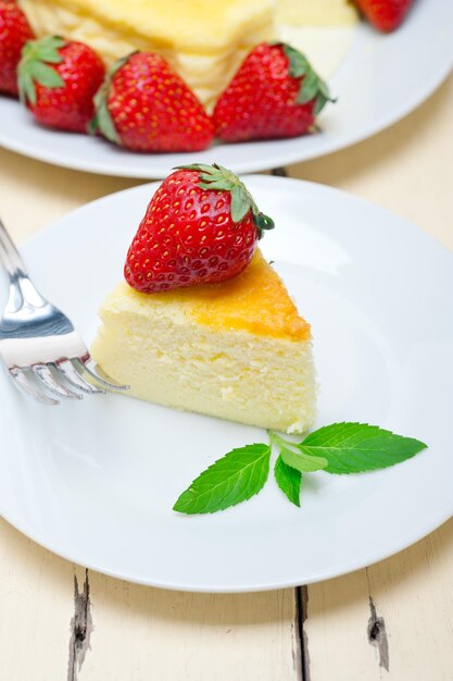 Close-up of cheesecake slice with strawberries in plate